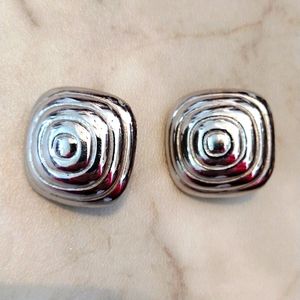 Vendom faux silver clip and tighten earrings.